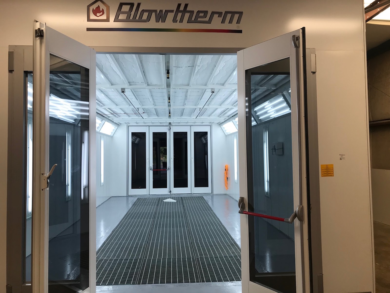 Professional auto body shop with technicians working